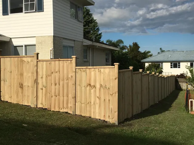 New timber boundary fence being built between two Auckland residential properties