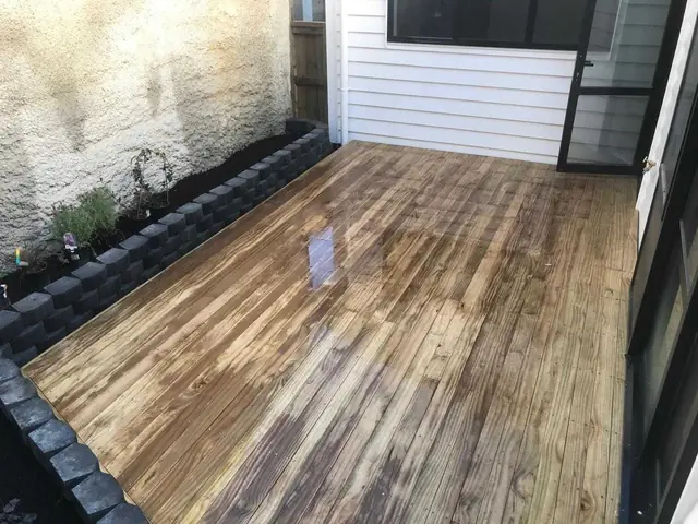 New timber deck with balustrade under construction on a sloping Auckland section