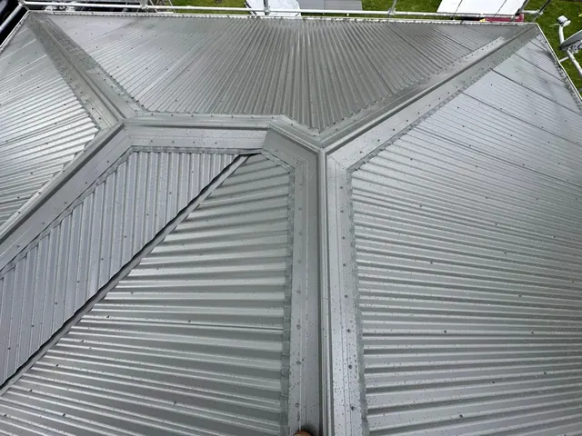 Long-run metal roof and concrete tile roof side by side on Auckland homes