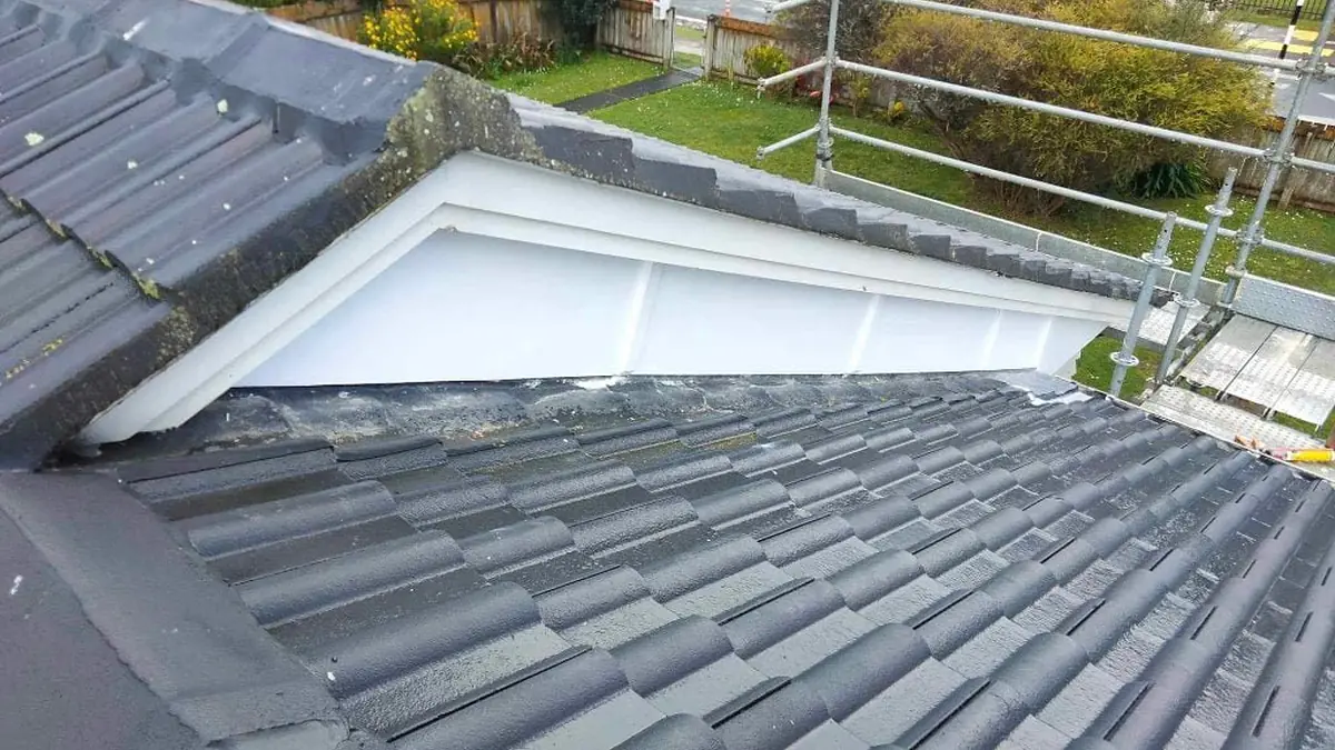Grey concrete tile roof with a white barge board, the kind of detail a roof maintenance checklist covers