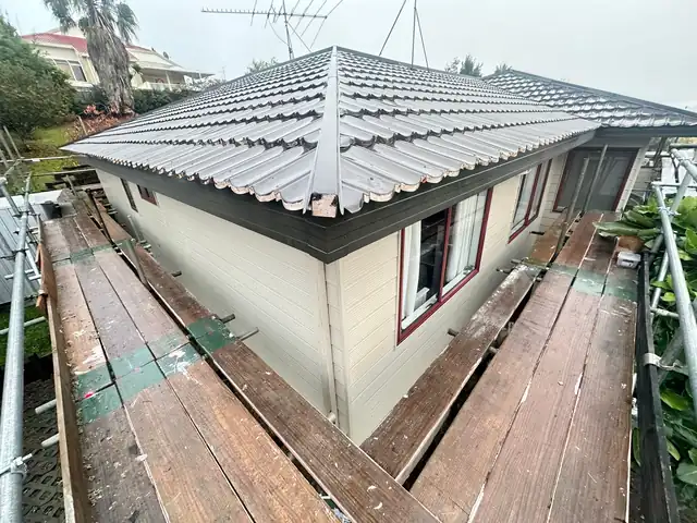 Completed metal fascia corner, West Harbour Completed corner of a Taylor fascia to metal fascia conversion on a tile-roof home in West Harbour, Auckland by My Homes Construct Ltd