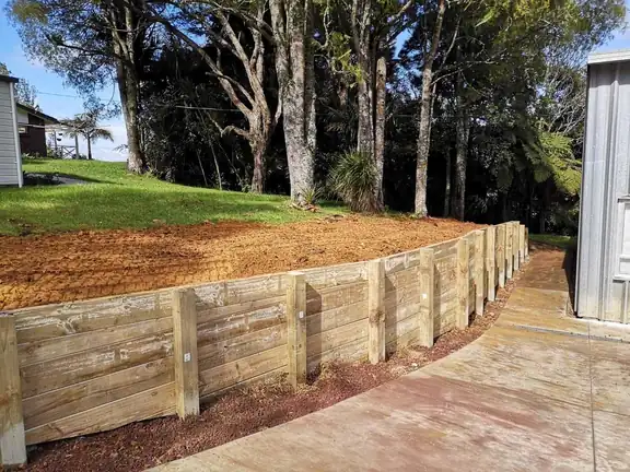 Retaining wall construction and groundwork in progress on an Auckland property