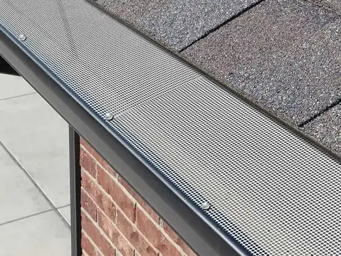 Scheduled gutter maintenance and guard fitting in progress on an Auckland property
