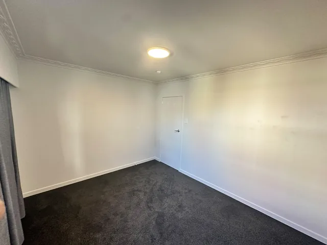New dark grey carpet installed in an Auckland bedroom by My Homes Construct Ltd
