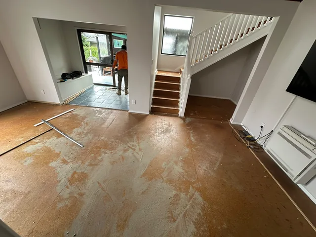 Subfloor preparation before laminate flooring installation in an Auckland living area