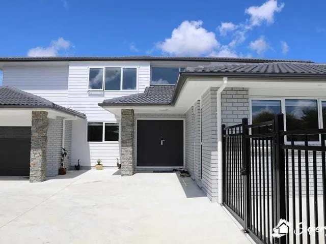 Completed exterior house painting and cladding finish on a residential project in Auckland