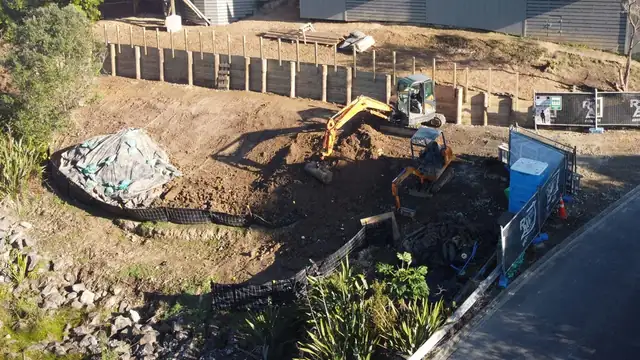 Excavation and timber pole retaining wall under construction on an Auckland site by My Homes Construct Ltd