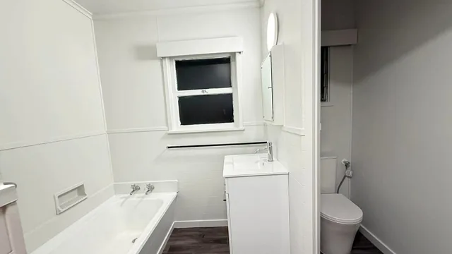Waterproof vinyl plank flooring in a renovated Auckland bathroom by My Homes Construct Ltd
