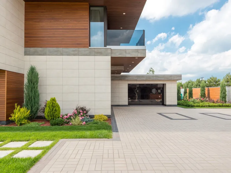 Paved driveway and garage approach with landscaped edging, the kind of driveway and civil work My Homes Construct Ltd carries out for Auckland homes