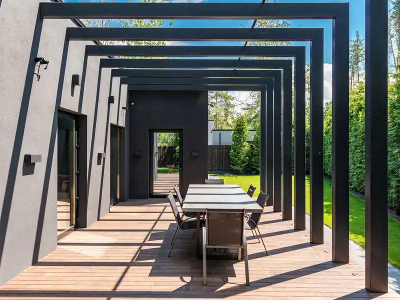 Timber deck under a slatted pergola with an outdoor dining setting, the kind of deck and pergola build My Homes Construct Ltd delivers for Auckland homes