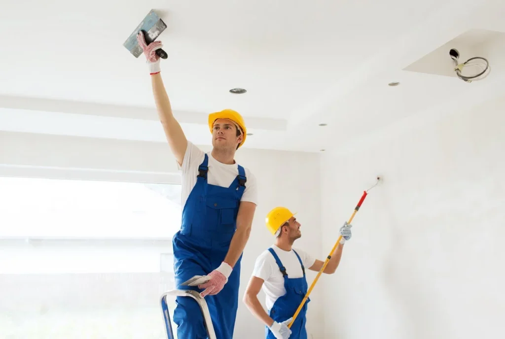 two guy painting the celling in auckland